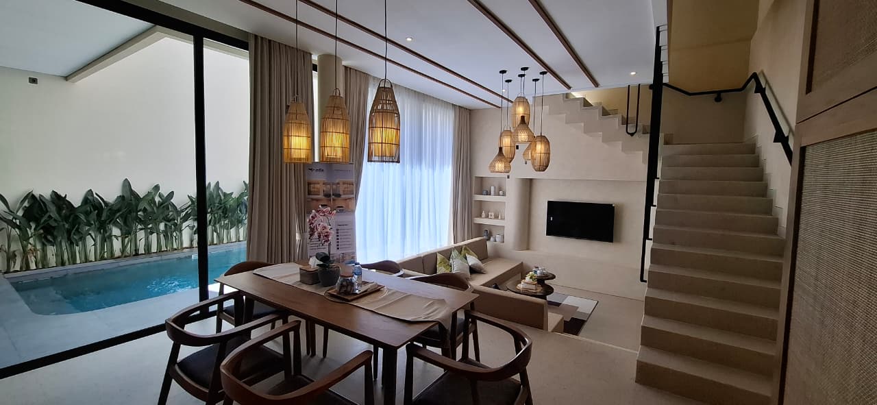 Jimbaran Hill show unit — living and dining room opening to the pool